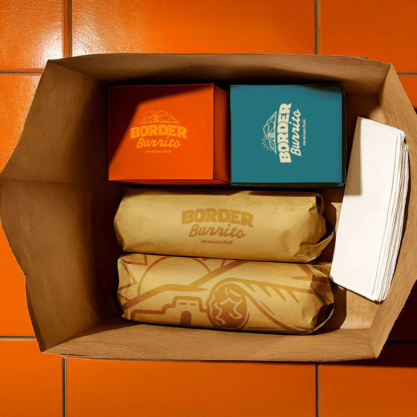 Border Burrito to-go bag with wrapped burritos and branded boxes